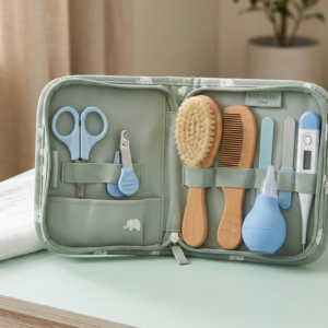Baby grooming kit for newborns with nail clipper, safety scissors, soft brush, comb, and baby care tools arranged in a compact storage case
